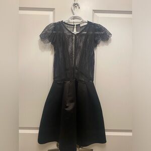 Black dress from Sandro with lace top and puffy from waist